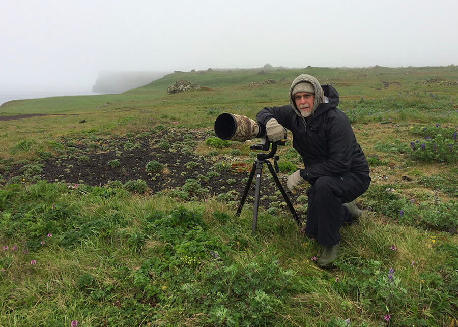 Chris Cunningham on tundra above cliffs with sea bird nesting colonies, St. Paul Island, Pribilof Islands, Alaska